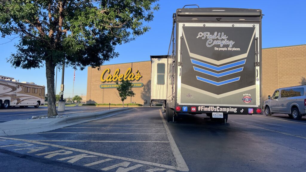 Cabelas with FindUsCamping 5th wheel parked in their RV lot
