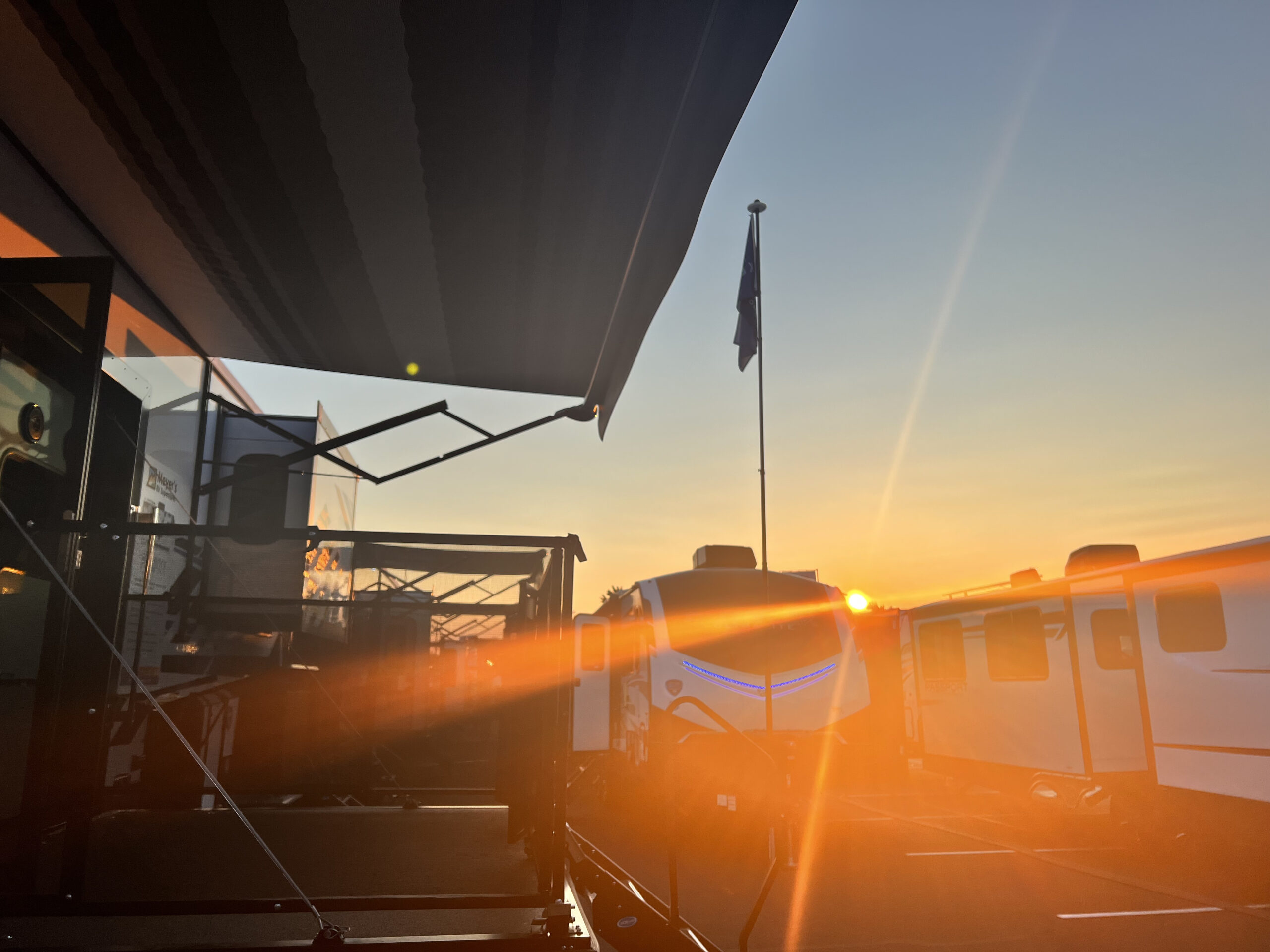 Sun setting over the RV show casting a beautiful view over a side patio RV