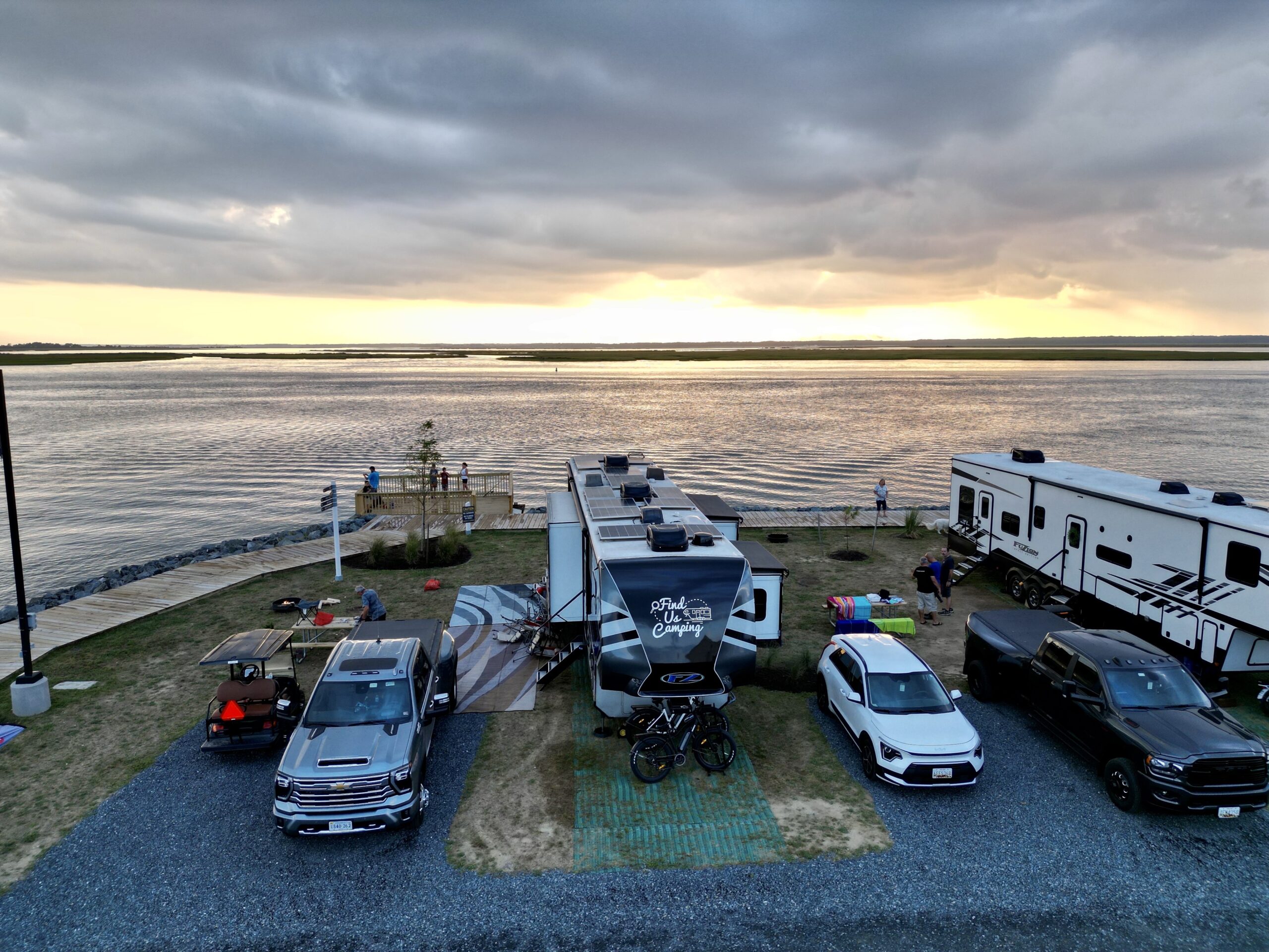 Aerial view of an RV with Finduscamping solar panels on top, parked at the Eastern Shore.The solar panels are absorbing the sunlight and generating electricity for the RV.