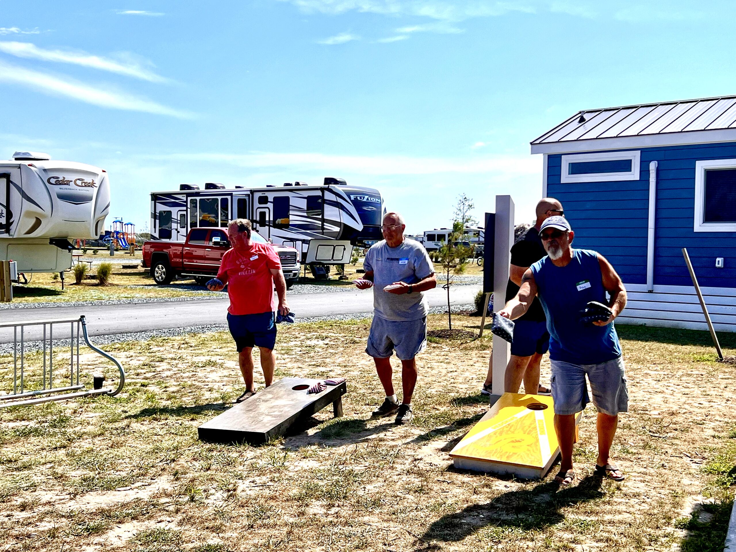 FindUsCamping Villagers playing a friendly game of cornhole