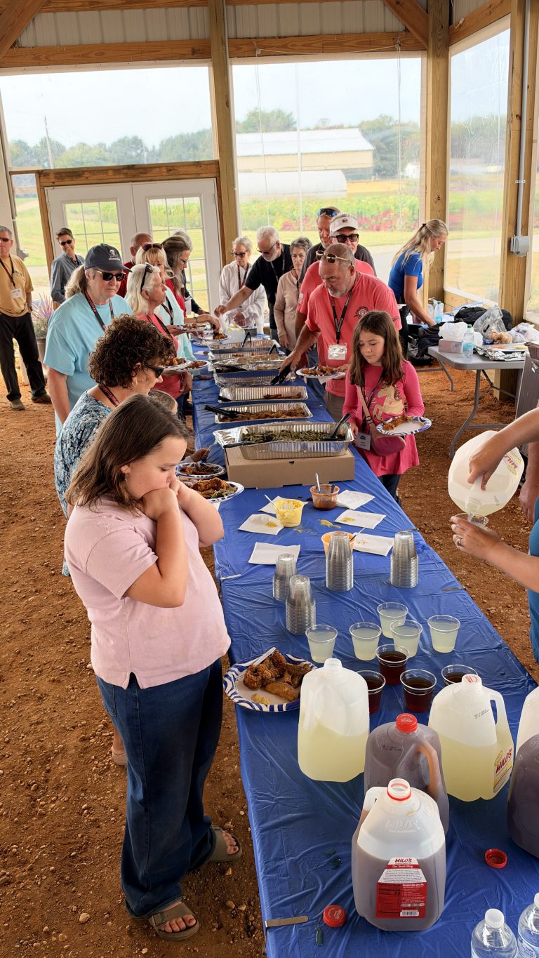 Villagers lining up for a home-cooked meal in the barn