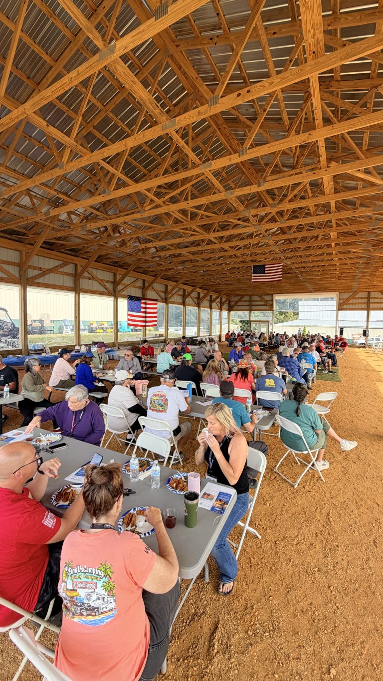 The whole Village sharing a meal in the arena