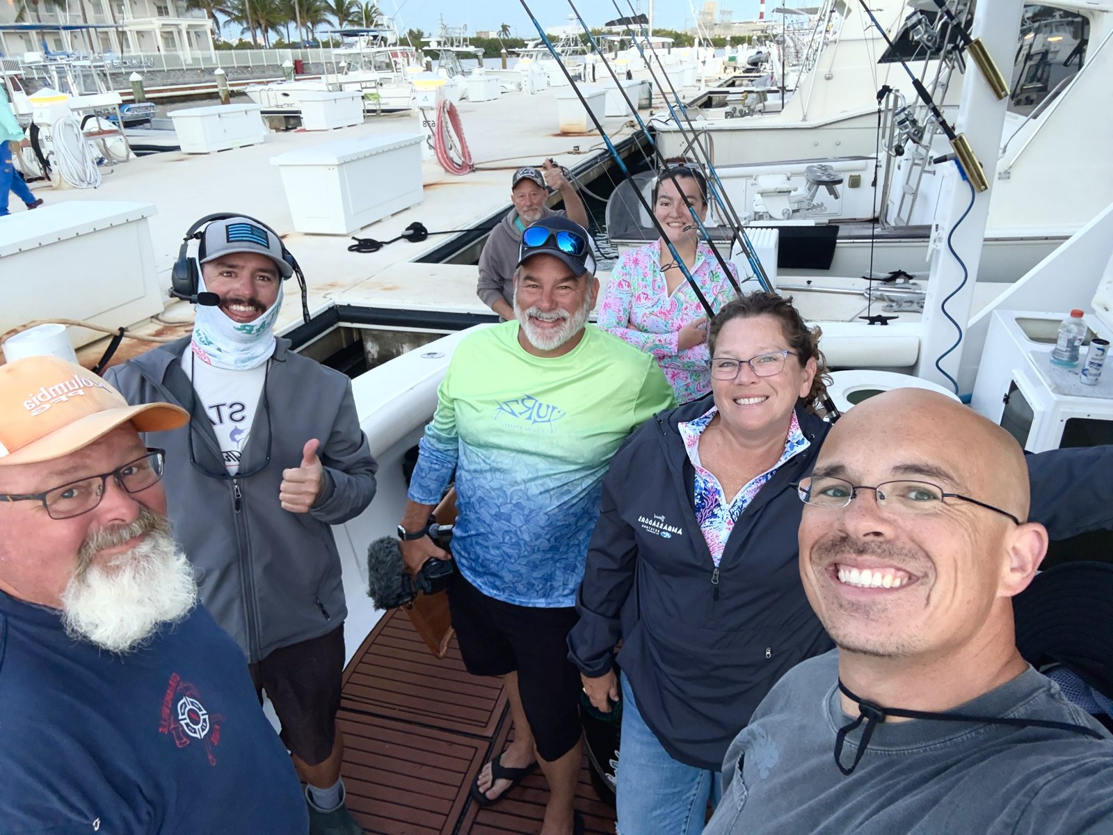 FindUsCamping Villagers smiling in a selfie on a fishing charter boat at the marina