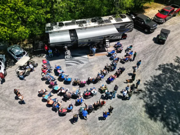 RVers gathered around the FindUsCamping Mobile Display Unit