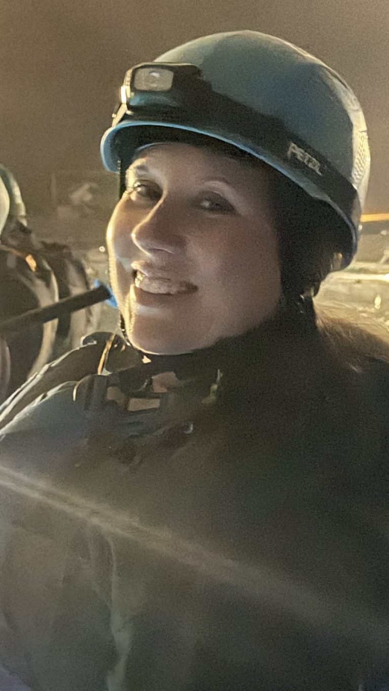 Villager in a helmet with a headlamp on the cave kayak tour