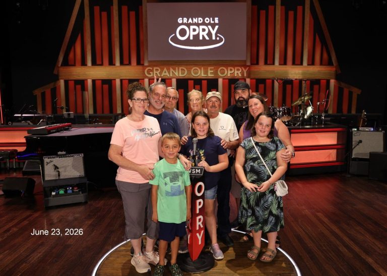 FindUsCamping Village group photo on the Grand Ole Opry stage